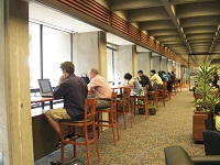 New 3rd floor lounge with students using bistro seating by windows