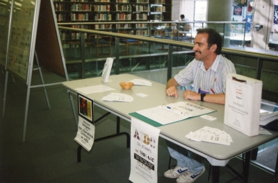 Photograph of Blair Henshaw at his Aids on Stamps exhibit at the Vancouver Public Library in 1996