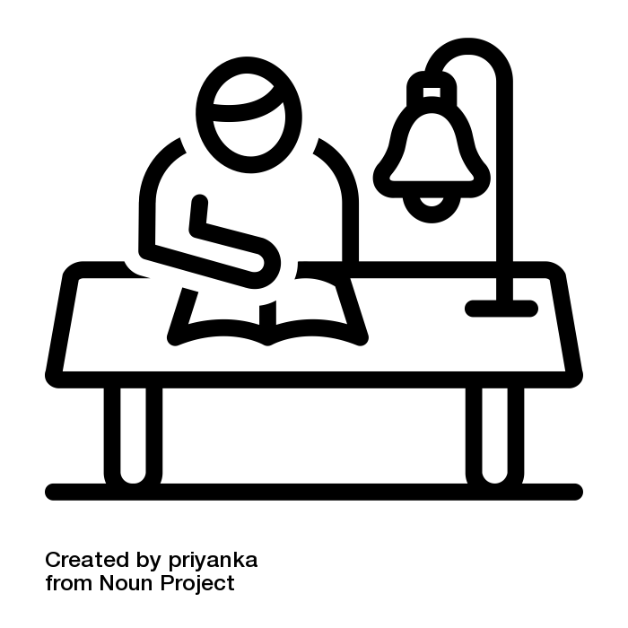 stick figure studying book at a desk with a lamp