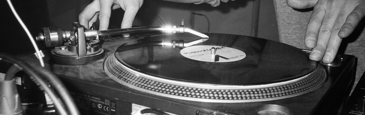 Hands with turntable and vinyl LP.