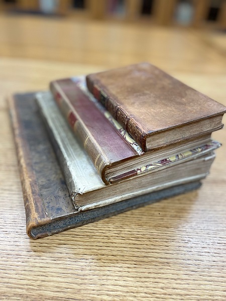 Stack of books demonstrating various sizes of the book design