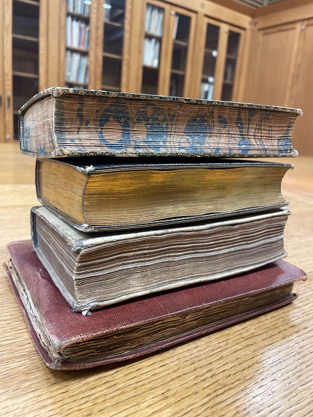 Stack of books demonstrating decorative designs of page edges