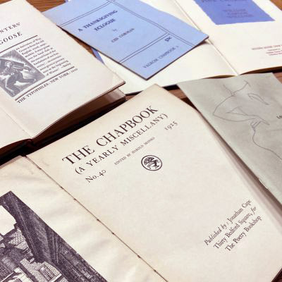 Detail of a selection of older poetry chapbooks, including the Poetry Bookshop periodical, The Chapbook (1925) in the front of the image.