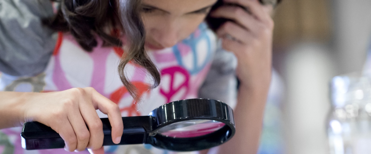 Student with magnifying glass