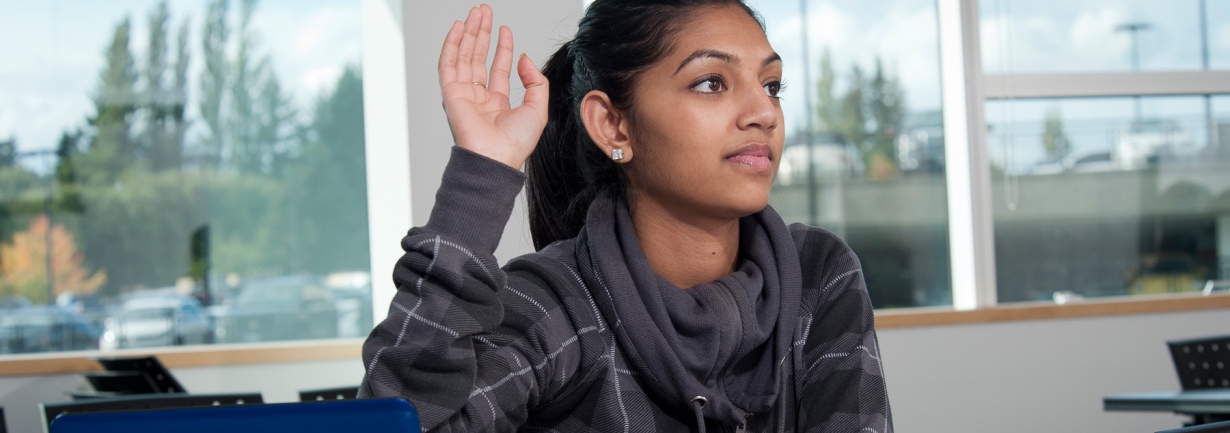 A young woman with her hand raised