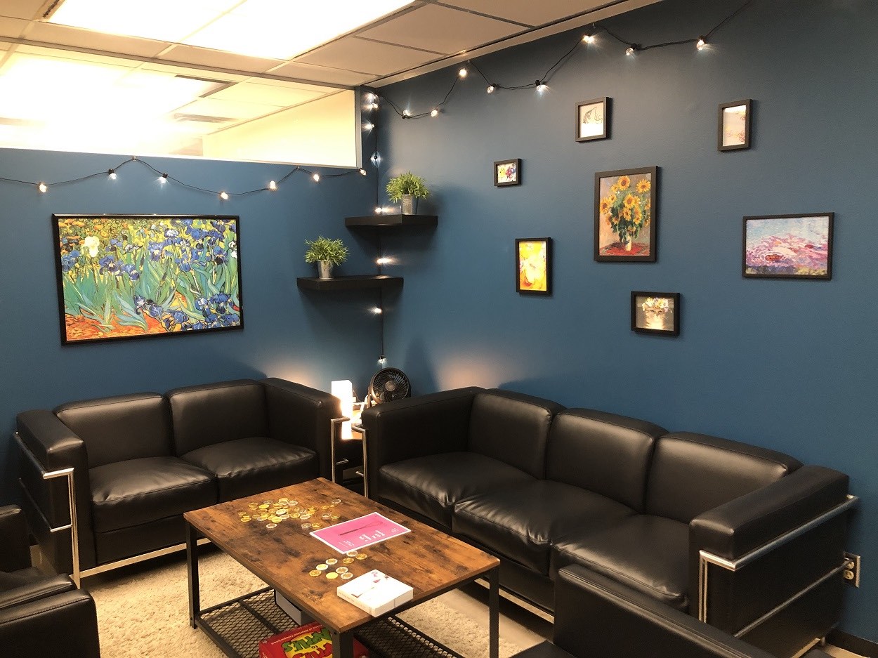 The newly renovated SLC Commons room, with couches, paintings, and plants