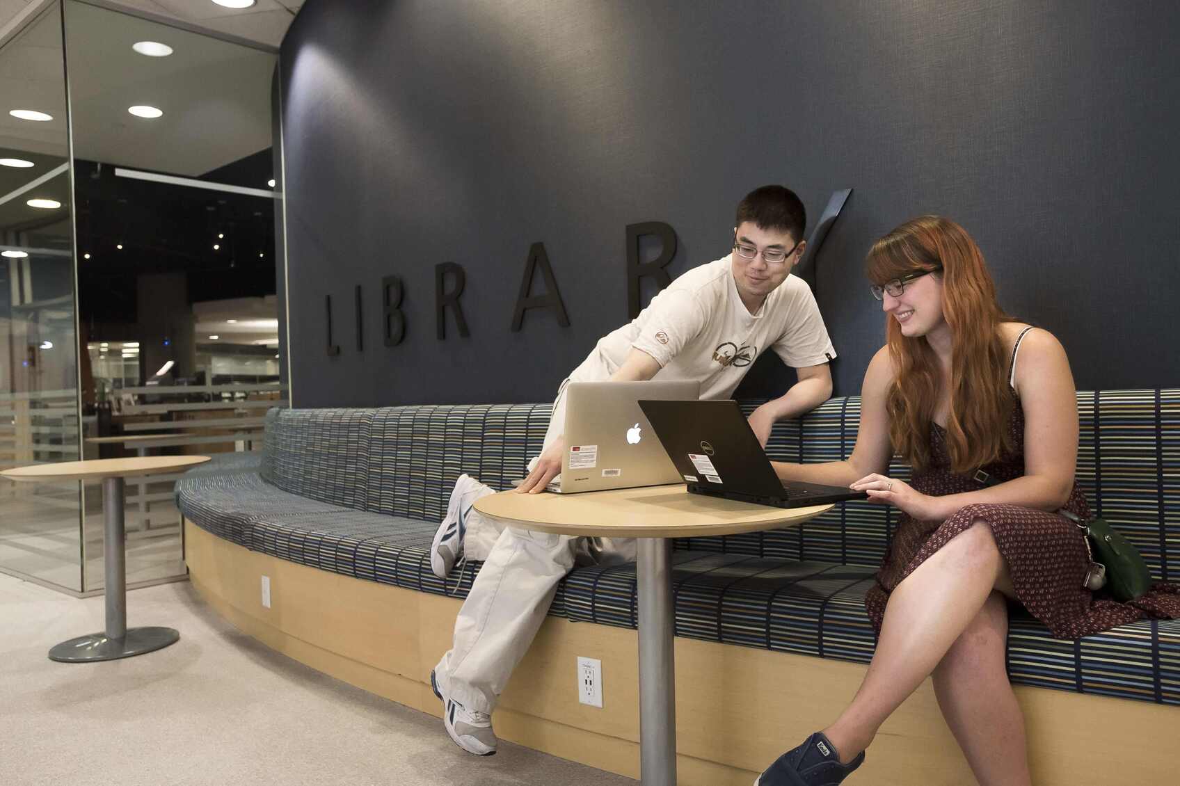 SFU Fraser (Surrey) Library Library patrons sitting at a table in the SFU Fraser library in Surrey