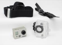 GoPro Hero 2 camera, housing, head strap, and helmet mount