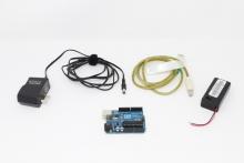 Arduino starter kit including Diecimila board, USB cable, and power supplies.