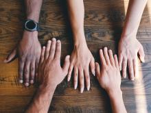 Reach out to our common world Hands of diverse skin colours