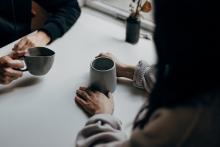 Two people having conversation over coffee