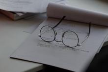 image of glasses on top of notepad