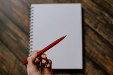 Drawing a blank? What's the right word? Person holding a red pen