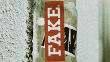 Feeling like a fake? You're not alone Lamp post with a sticker labelled 'fake'