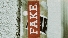 Lamp post with a sticker labelled 'fake'